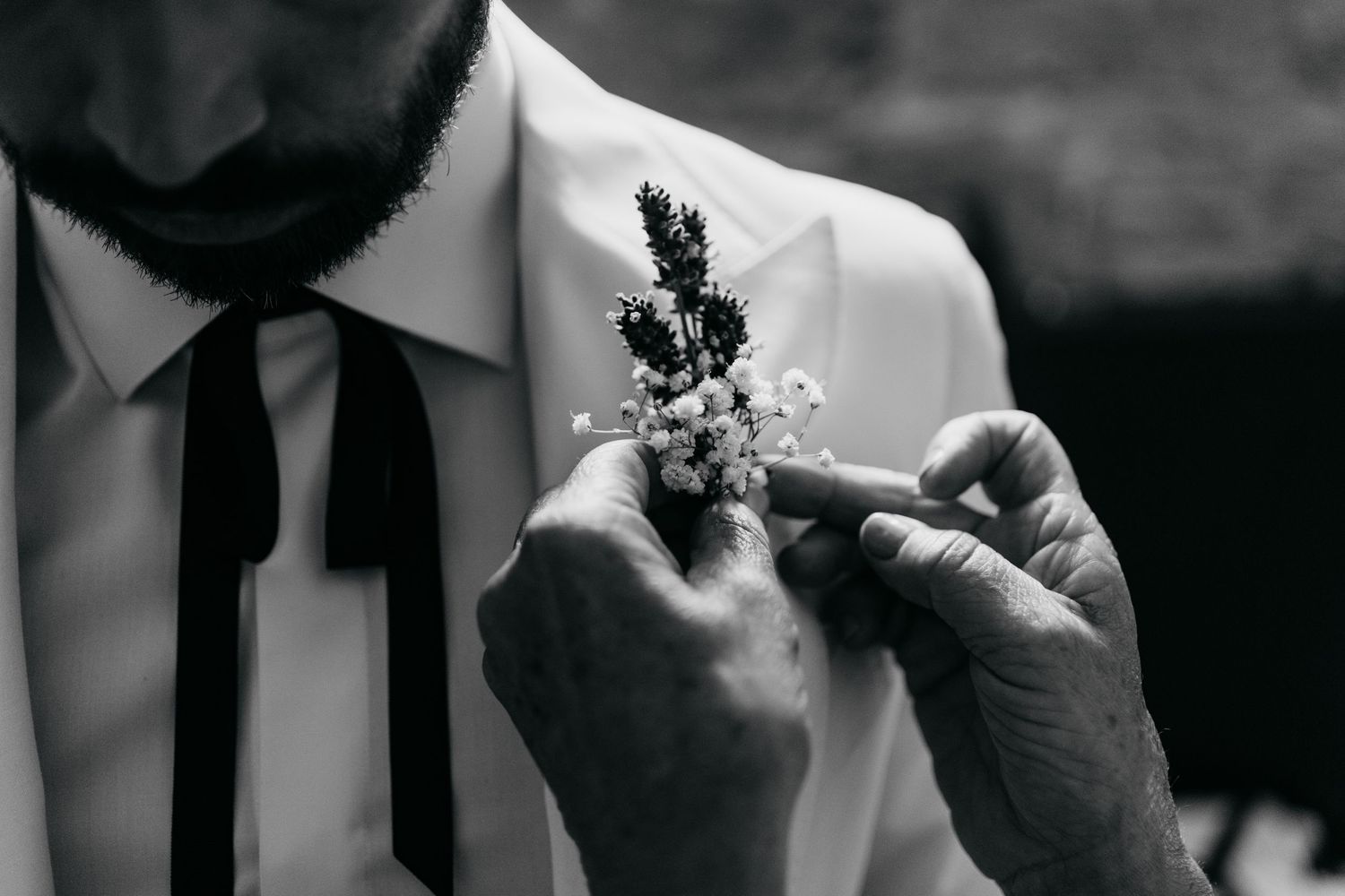 Black and white detail shots of wedding preparations in classic formal attire.