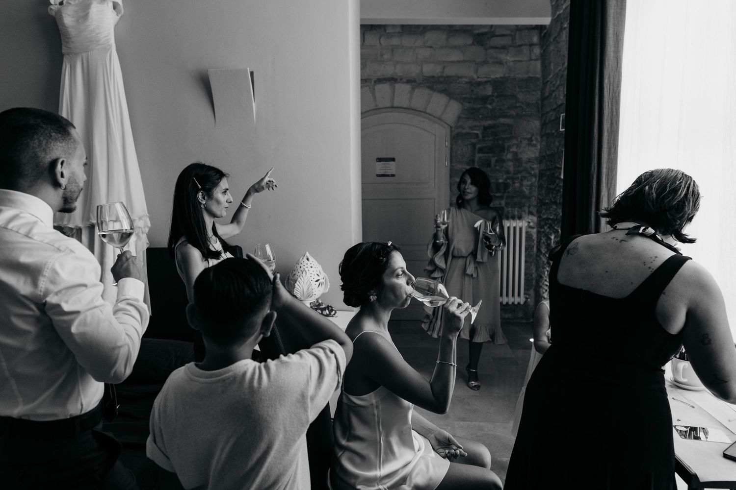 Black and white candid moment showing guests reacting with excitement at an indoor event.