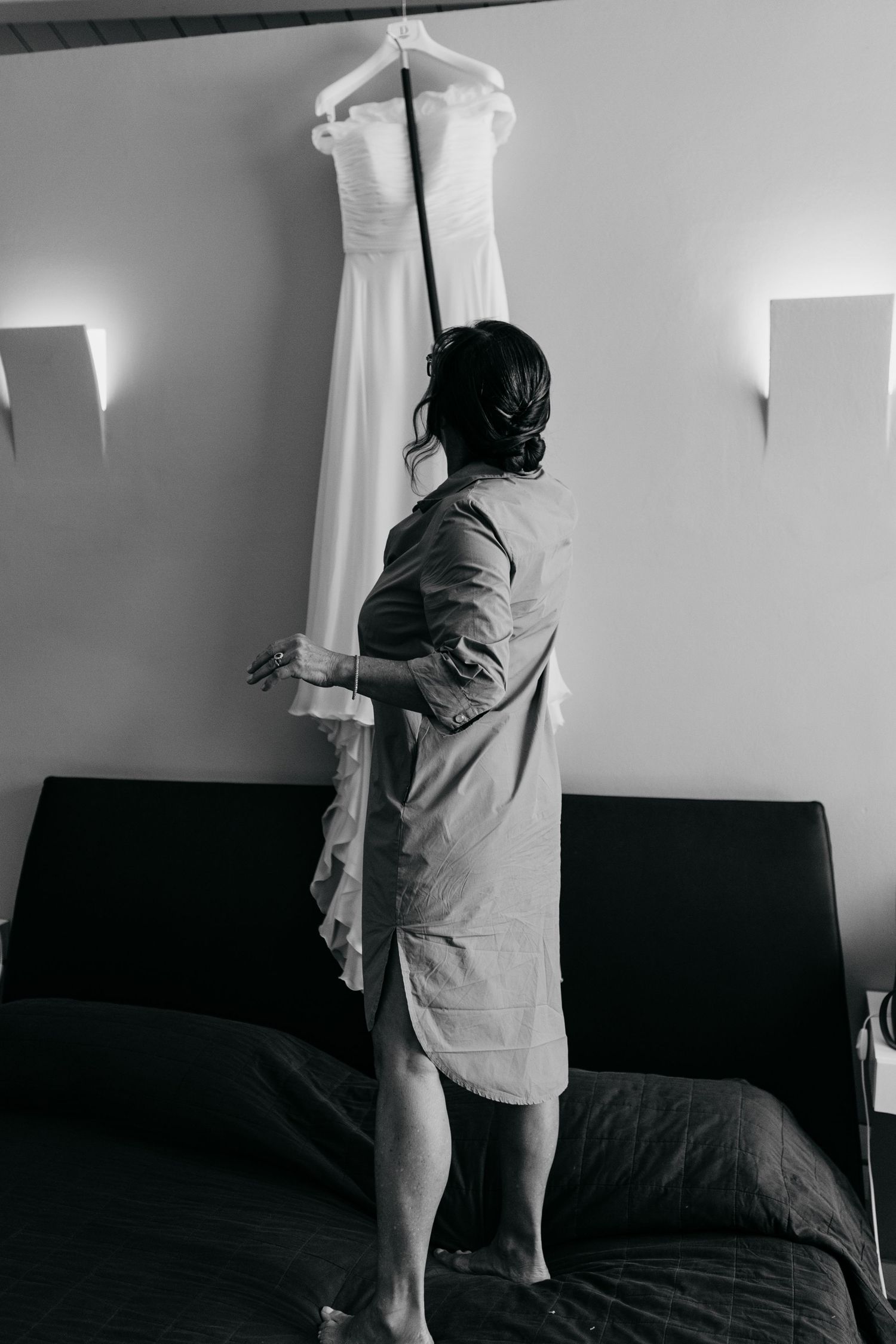 Black and white sequence showing curtains being drawn open in a room.