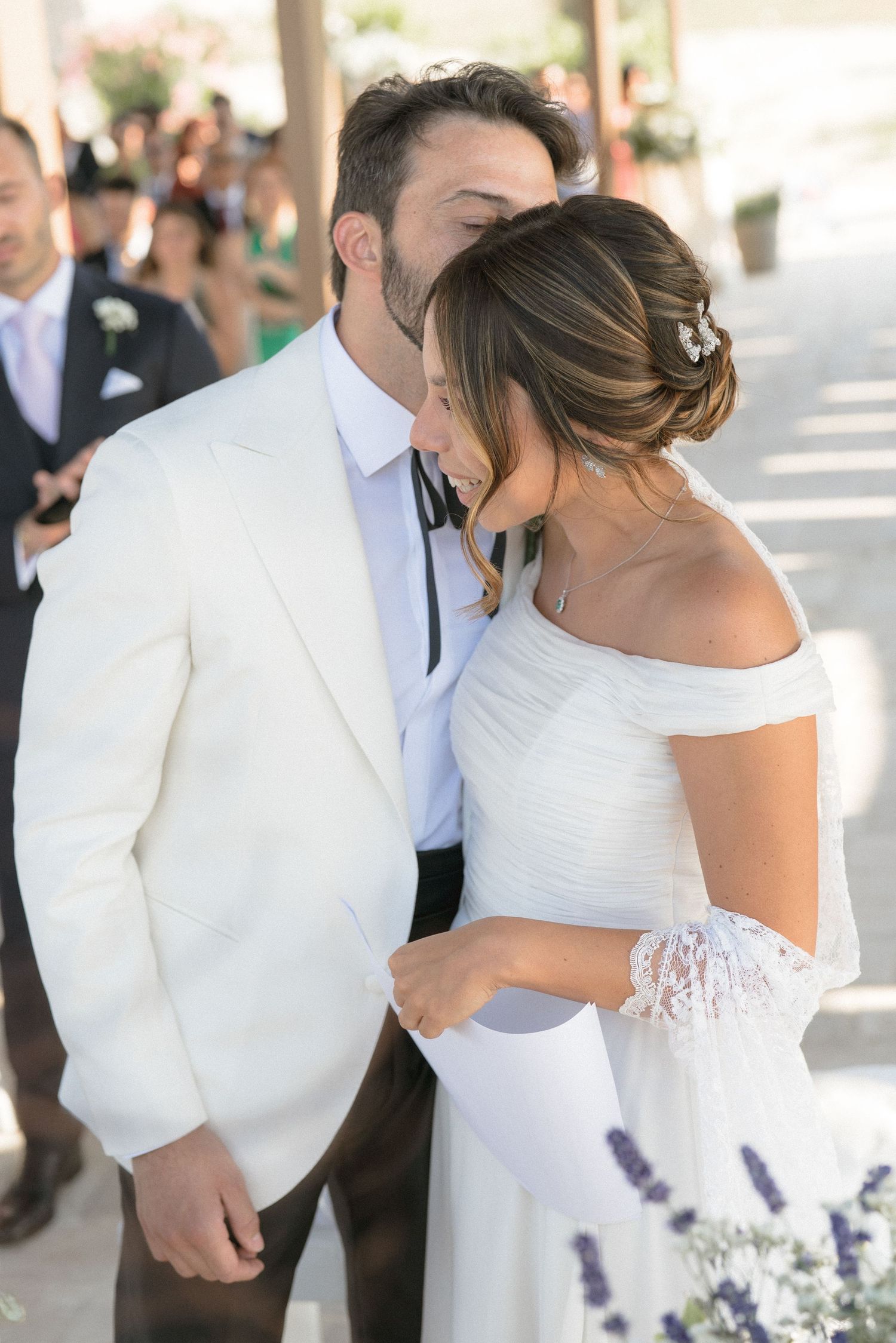 A couple shares a romantic dance together during their summer wedding celebration outdoors.