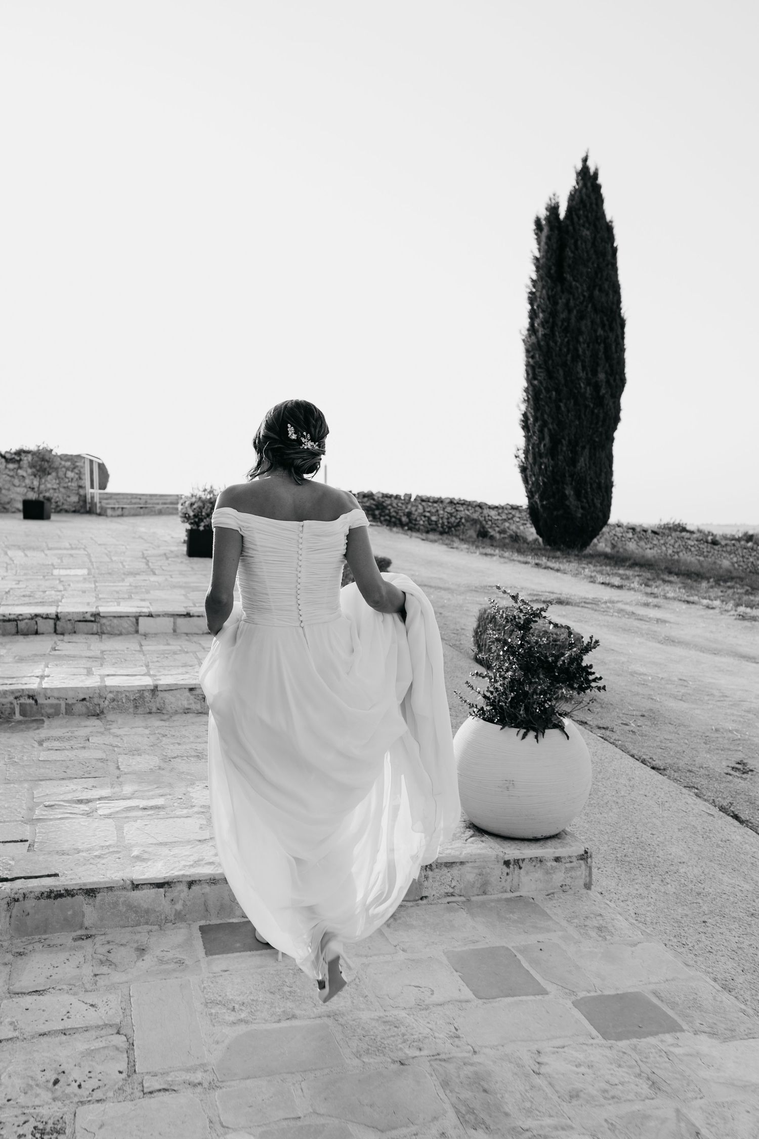 Black and white sequence of a bride walking gracefully against a minimalist backdrop.