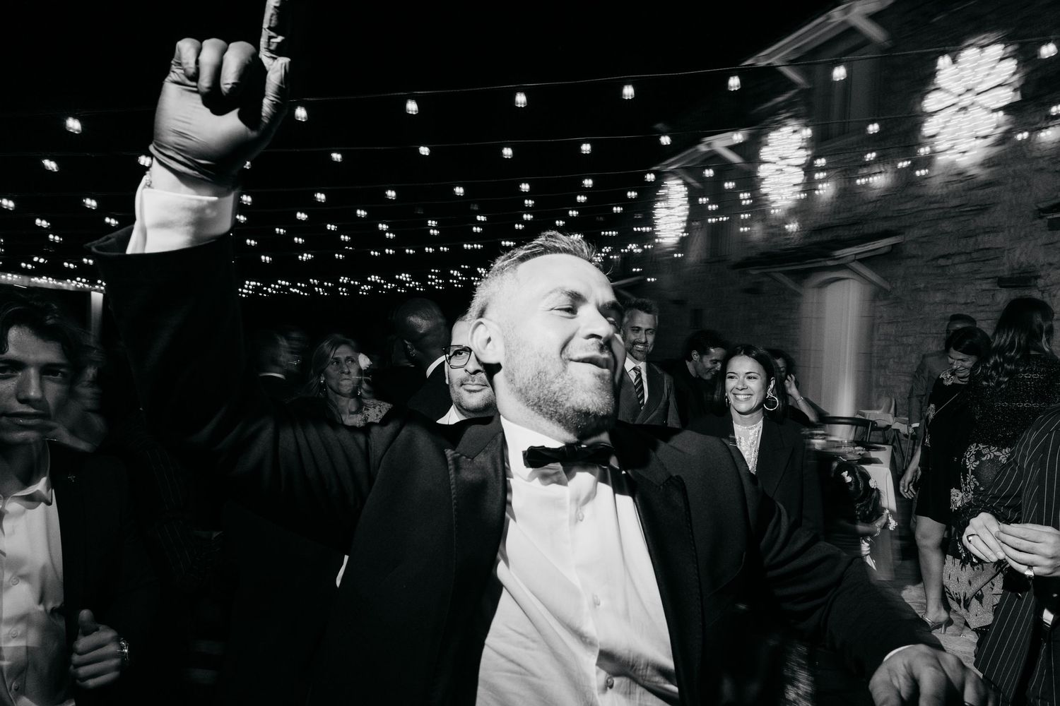 A black and white photo capturing the joy and celebration at an elegant evening event.