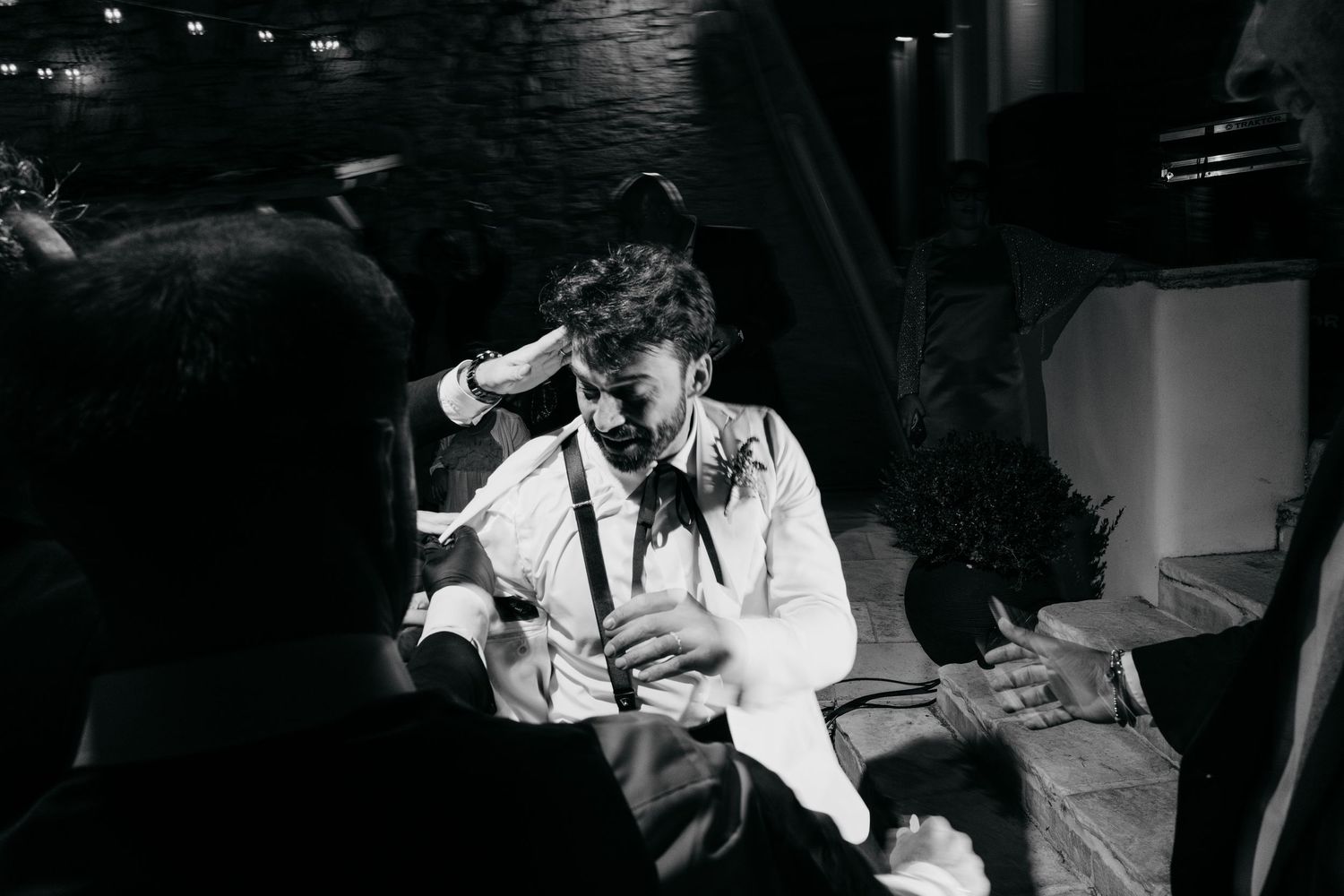Romantic black and white wedding dance photos captured in low light.