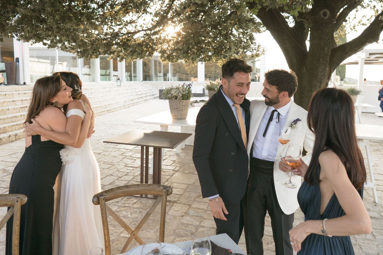 Guests mingle and socialize during a casual outdoor wedding reception.