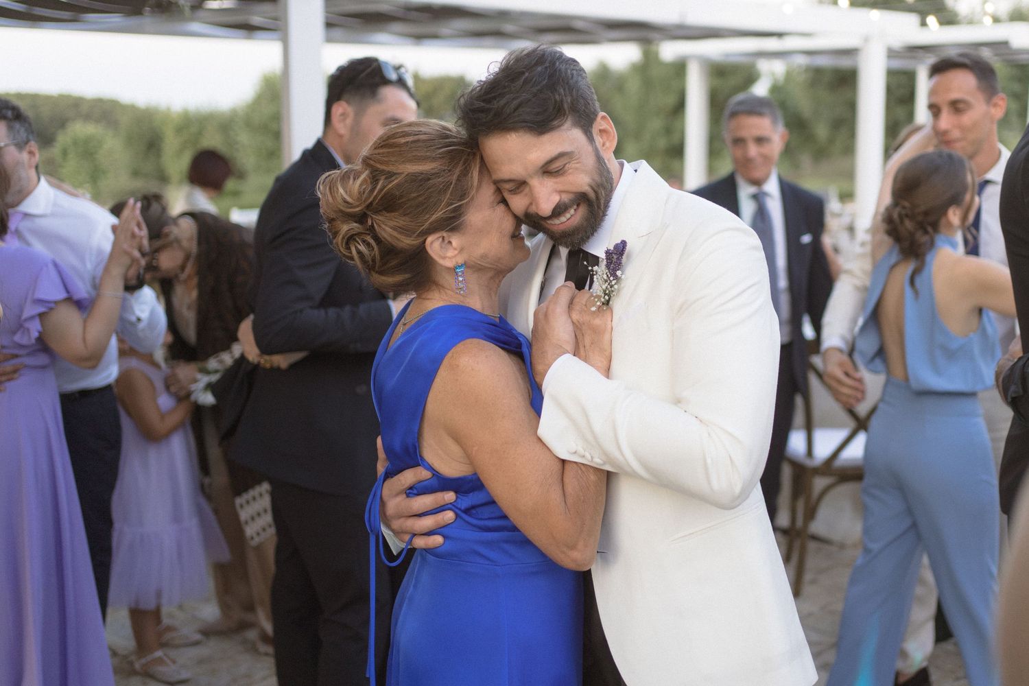 Wedding reception dance sequence showing guests in blue dresses celebrating with the newlyweds.