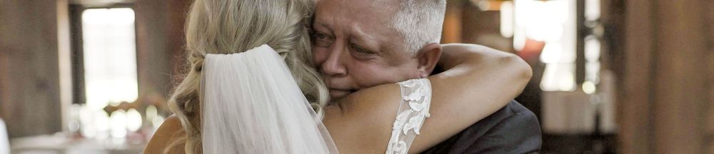 Two people sharing an intimate embrace while dancing at a formal event.
