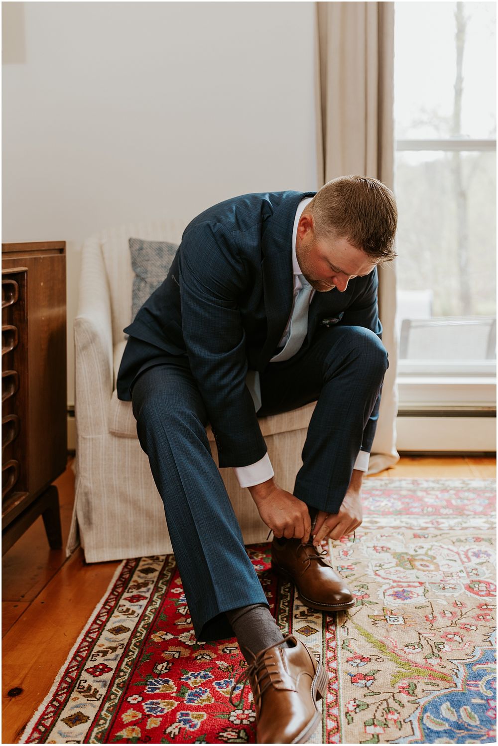 Groom getting ready in the Carriage House at The Preserve at Chocorua