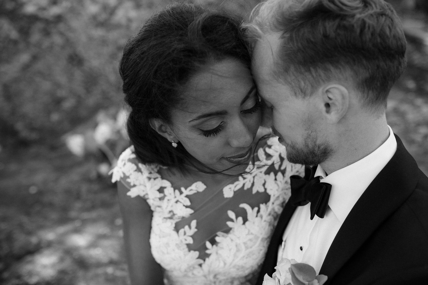 An intimate black and white portrait of a couple on their wedding day.