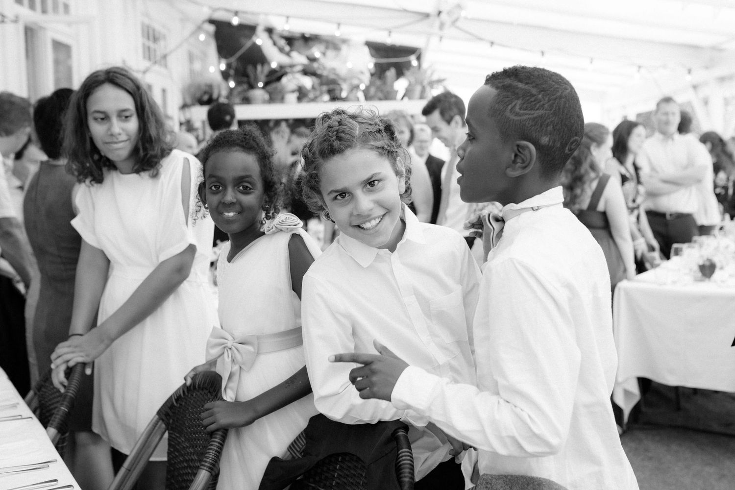 Students enjoying themselves at a school dance or social gathering in black and white photography.
