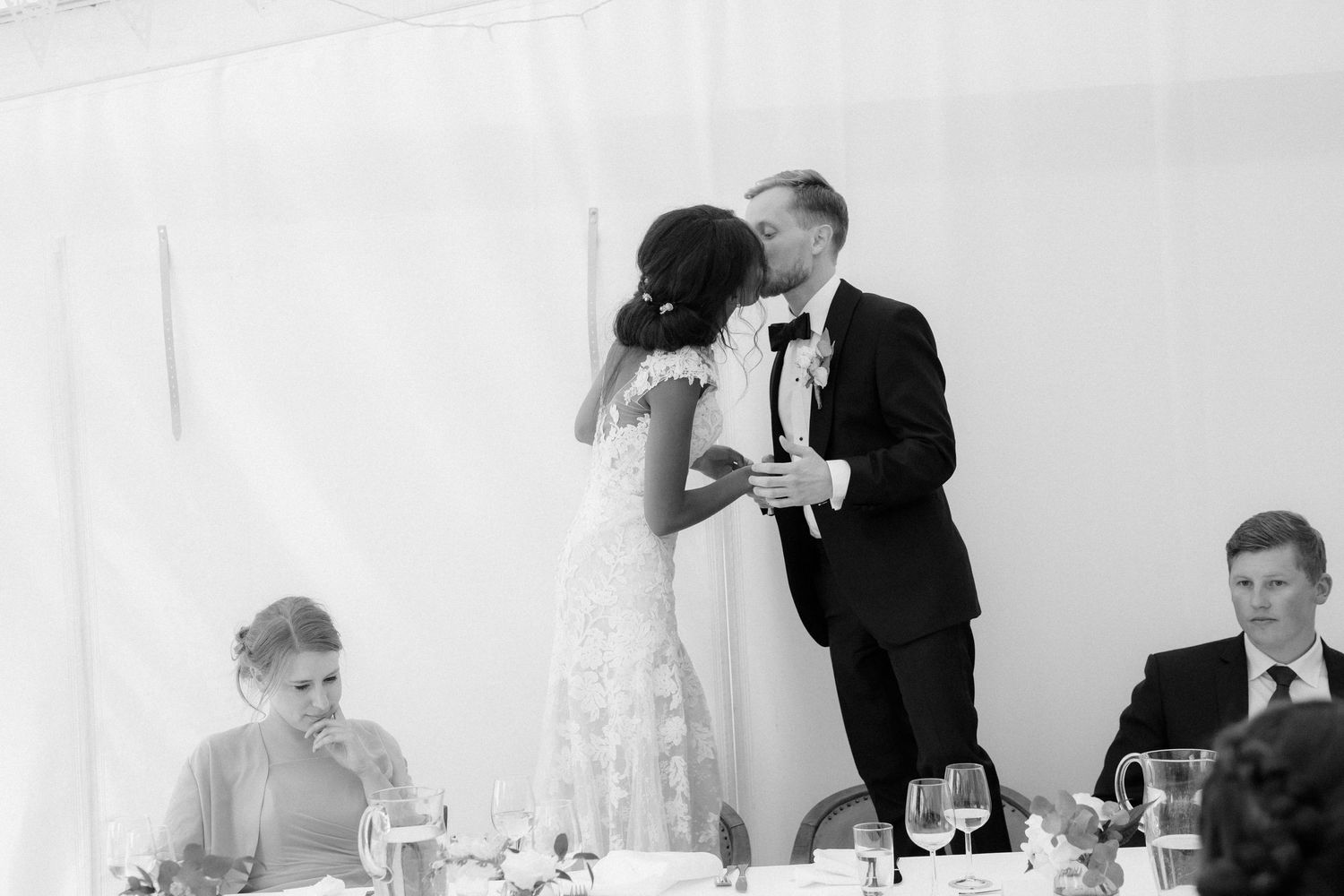 Intimate moment captured in black and white during a wedding reception dinner.