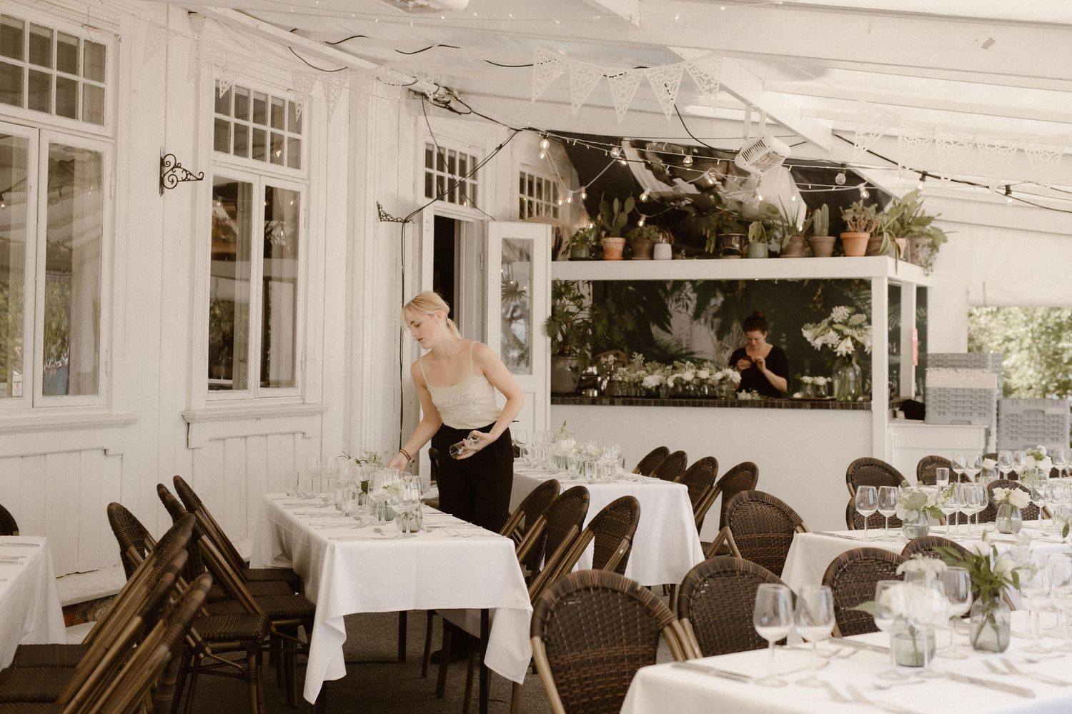 Vintage-style restaurant interior with white tablecloths and elegant place settings.