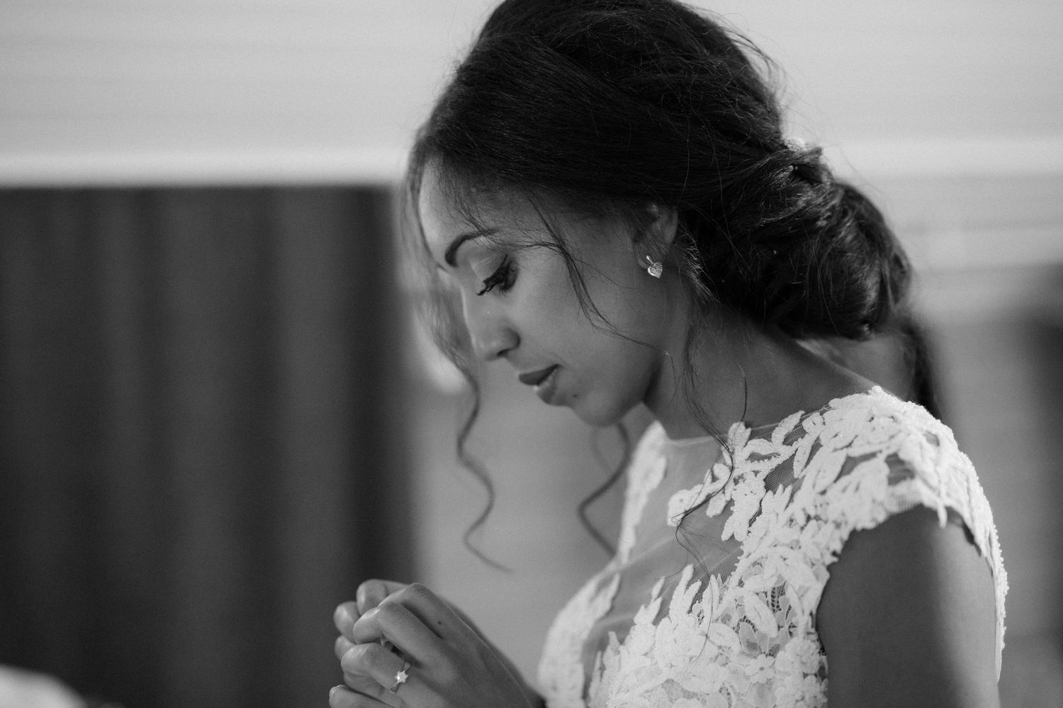 An intimate black and white portrait of a bride in lace with an elegant updo hairstyle.