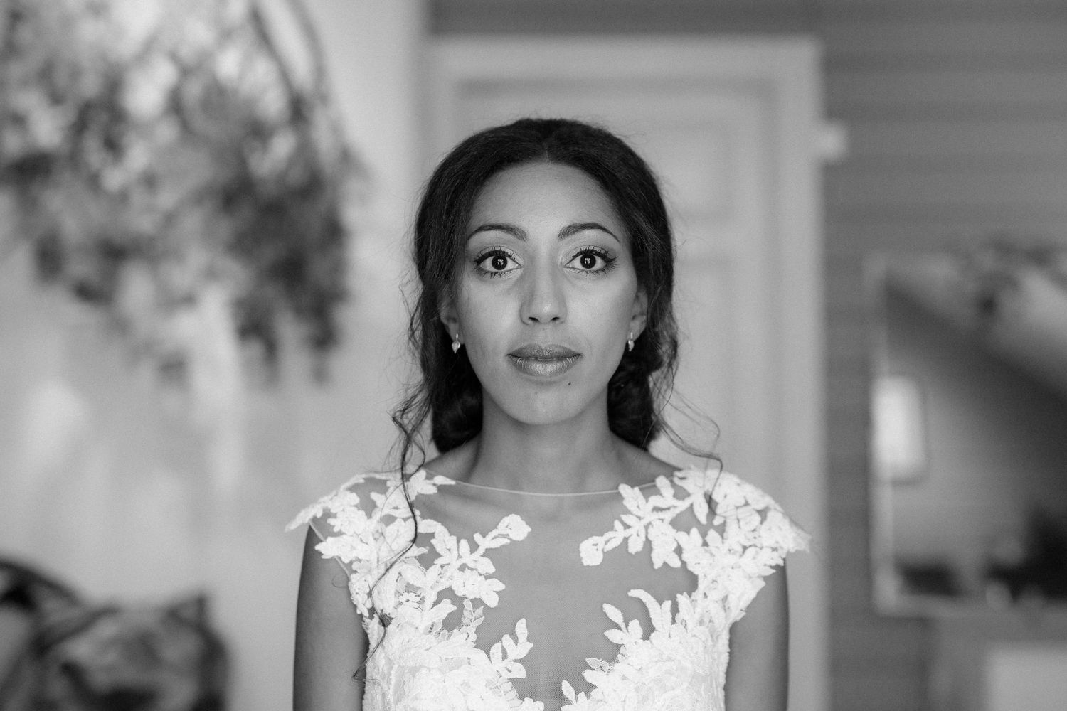 Close-up black and white portrait shot of a bride wearing a delicate lace wedding gown.
