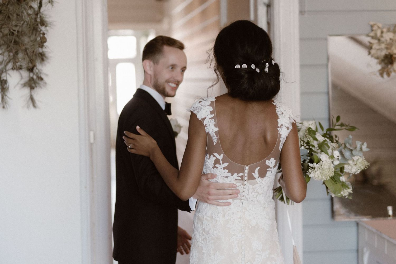 Tender wedding moment between newlyweds in natural light.
