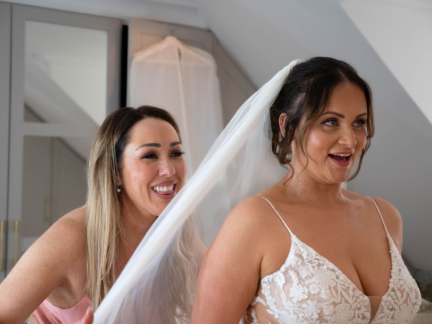 Bride and bestie fixing her vail