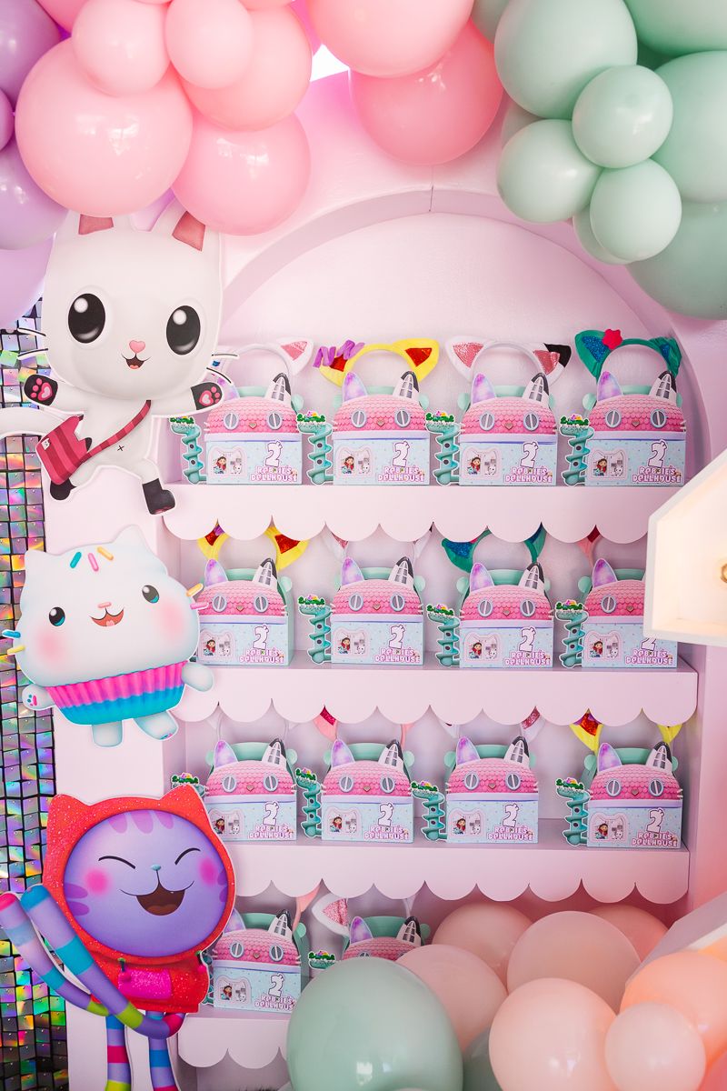 Colorful gift wall featuring personalized presents at a Gaby’s Dollhouse birthday celebration, photographed in NYC.