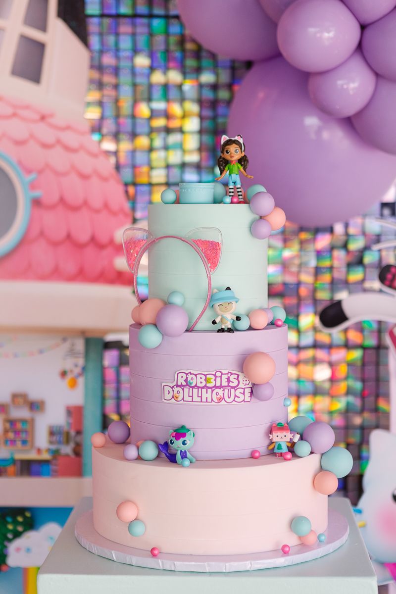 Gaby’s Dollhouse-themed birthday cake with playful pastel decorations, captured by NYC family photographer Paula Brearley.