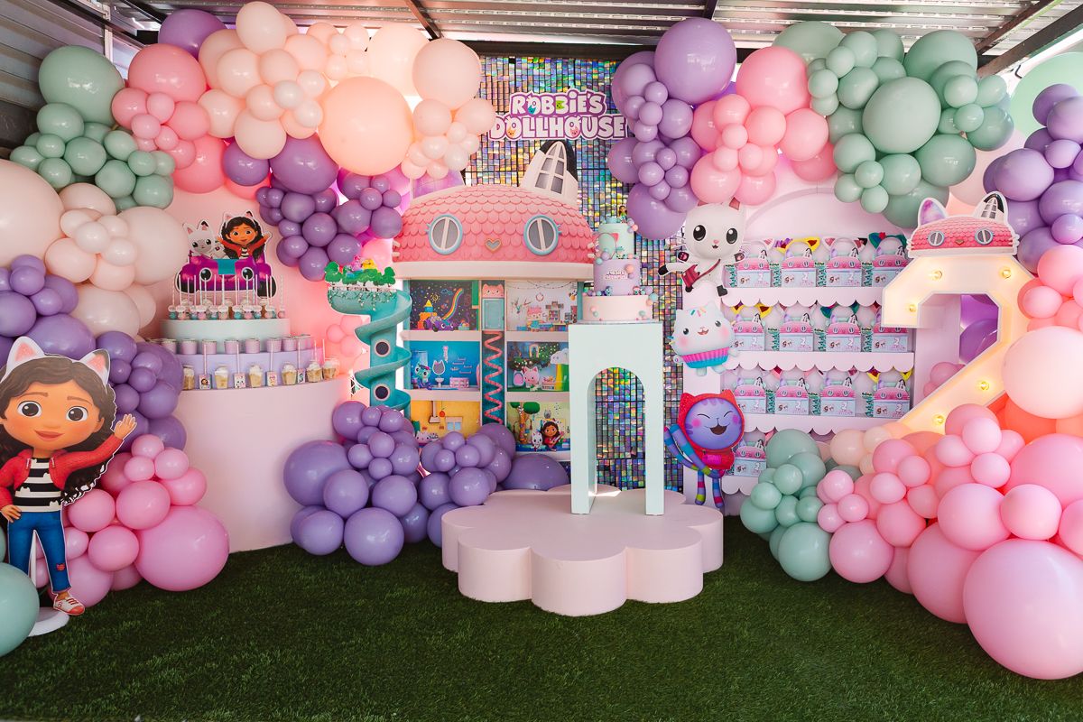 Full backdrop decor with a beautifully presented cake stand, creating a magical Dollhouse-inspired setting.