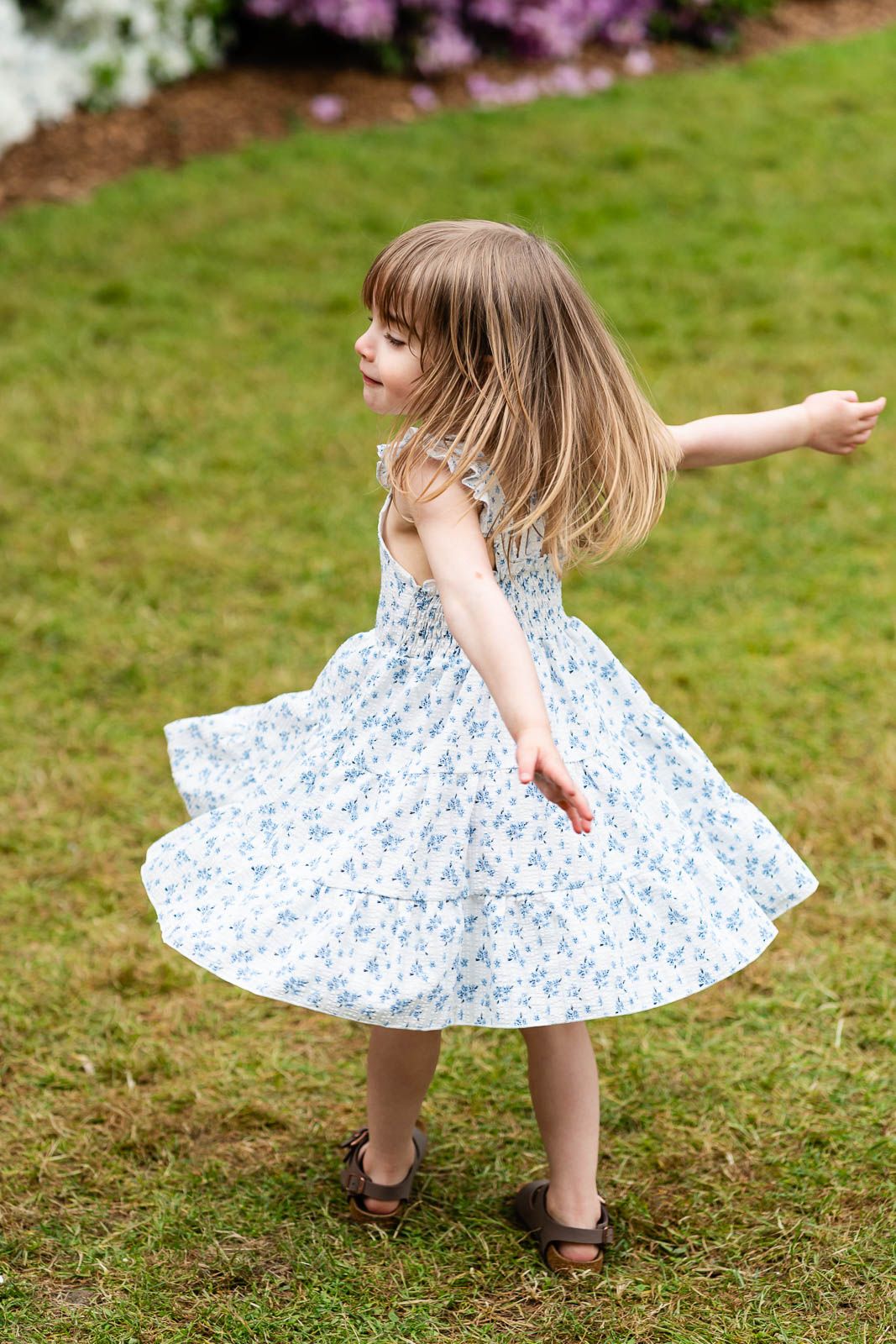 Daughter twirling around while smiling.