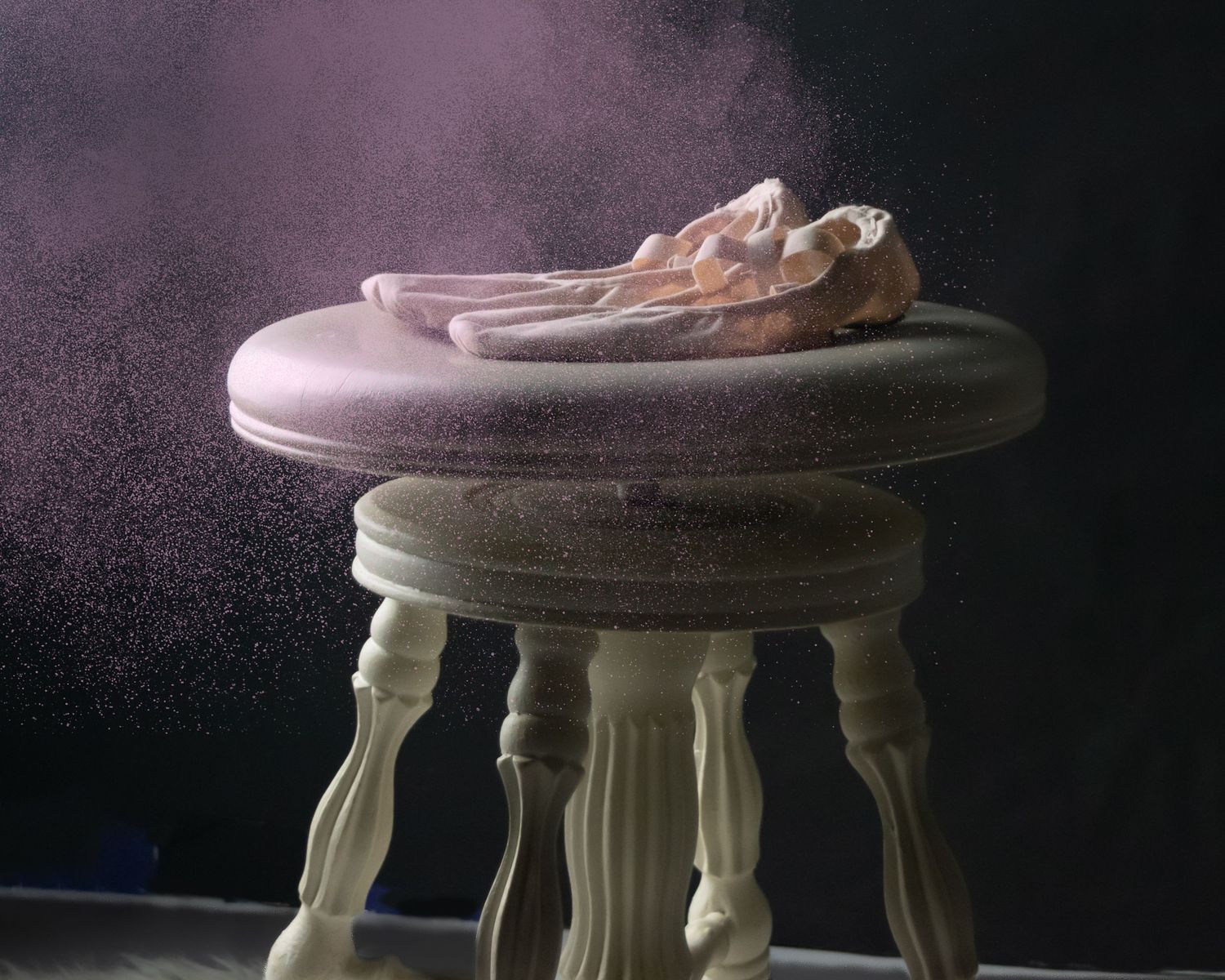 A wooden stool is captured through a sequence of manufacturing stages against a dark background.