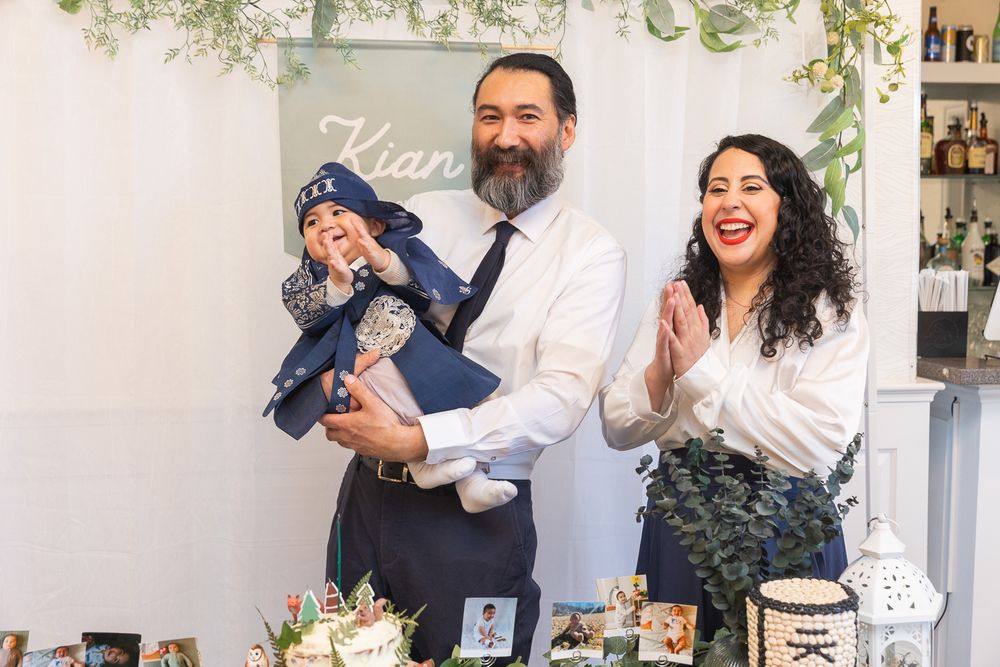 A joyful celebration at a baptism event with floral decorations and vintage decor.