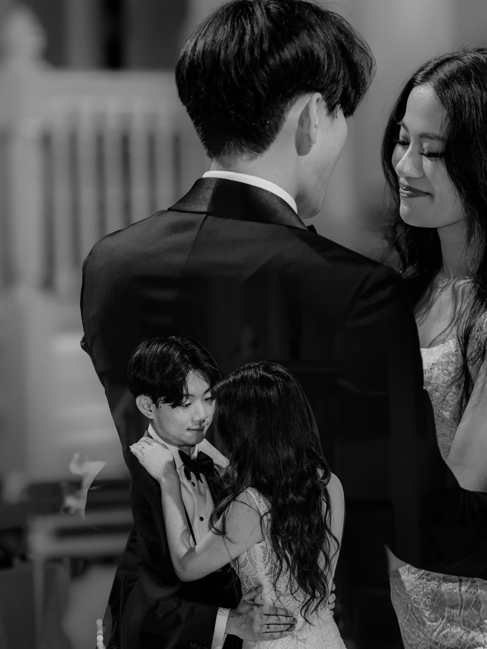 Black and white mirrored images of couples dancing at a formal event in elegant attire.