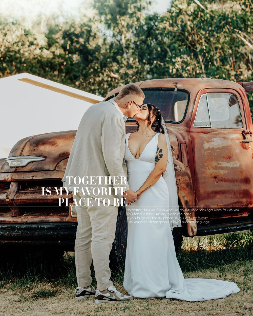 Romantic couple embraces by vintage rustic red pickup truck during golden hour wedding photoshoot.