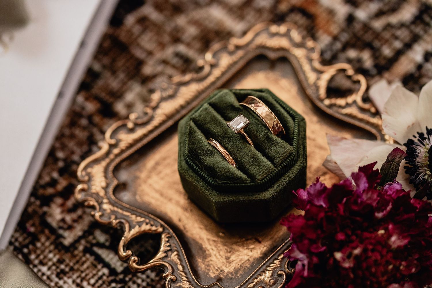 Elegant wedding rings in green velvet box on vintage gold tray with florals, perfect for luxury bridal flat lay and wedding detail photos.