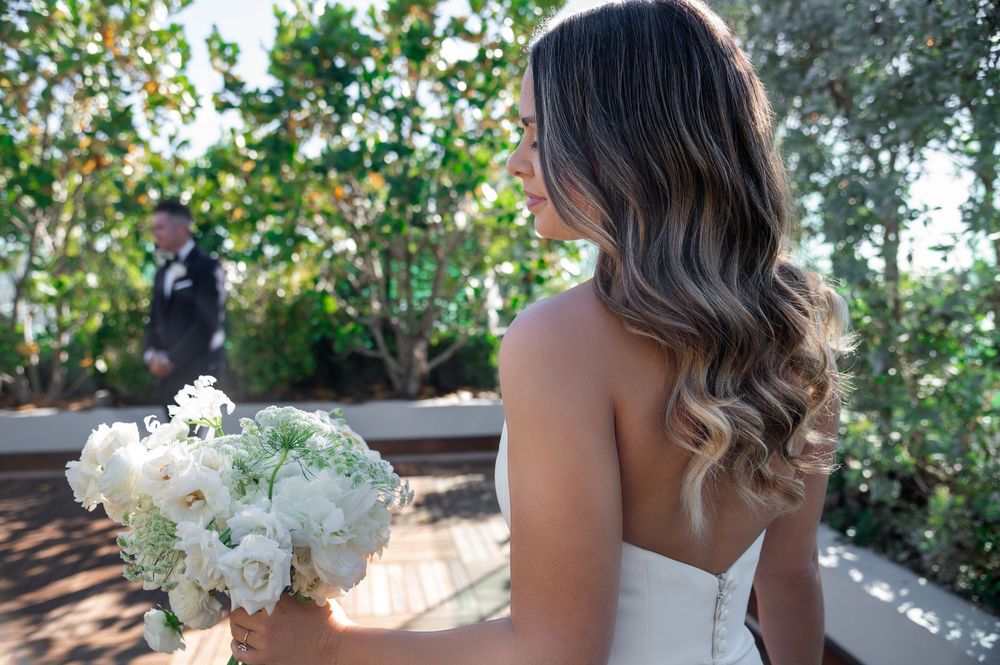Champagne toast under string lights on rooftop, captured by wedding photographers in Palm Beach