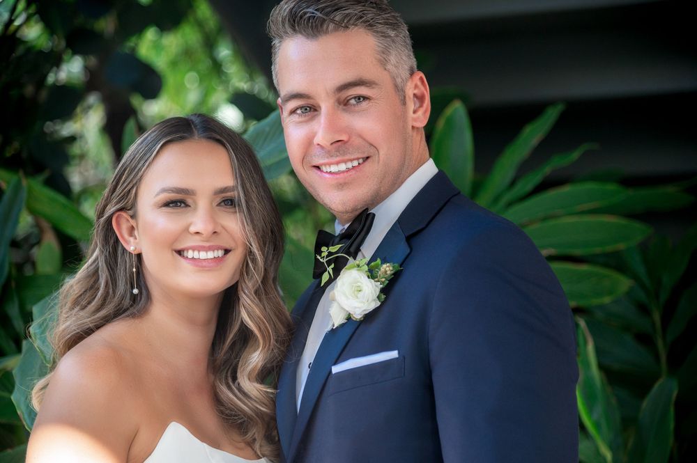 Groom’s rooftop portrait with tropical foliage in background by Florida wedding photographers
