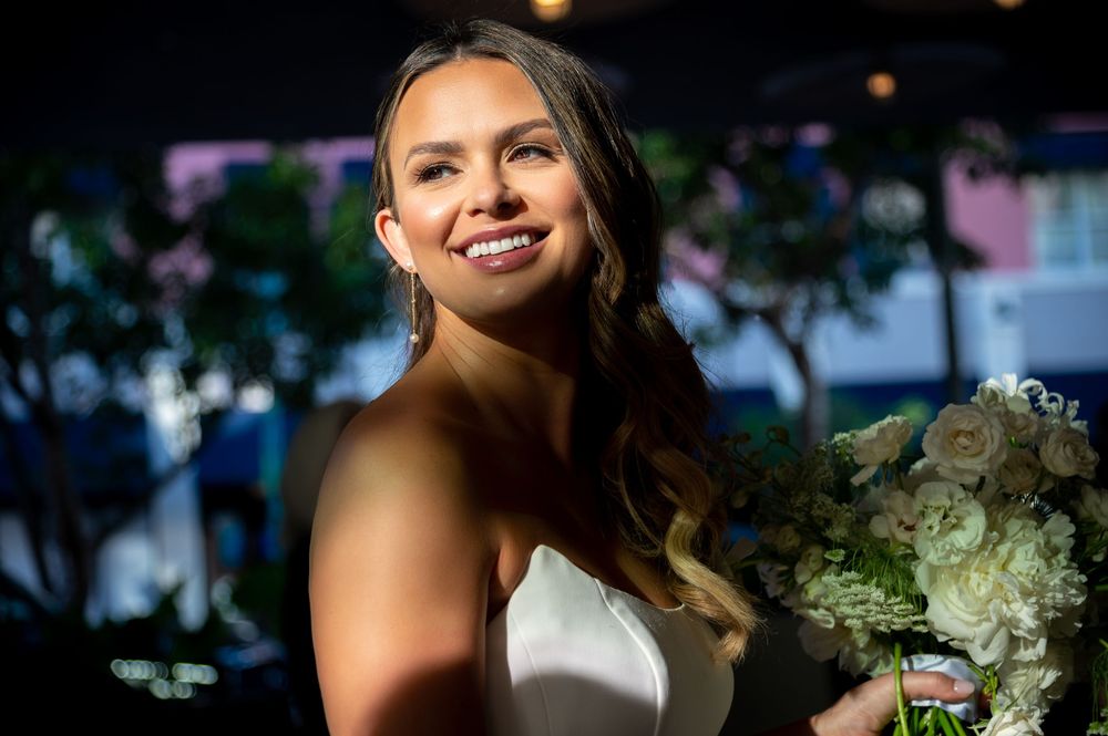 Emma’s bridal portrait with sleek ponytail and designer gown by wedding photographers in South Florida