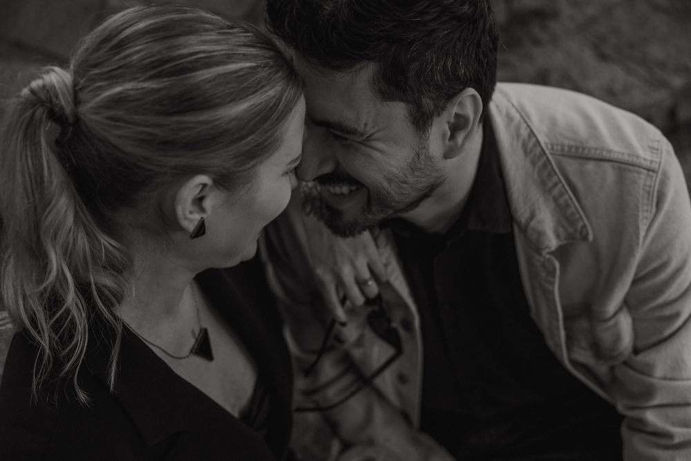 A romantic black and white photo of a couple sharing an intimate moment together.