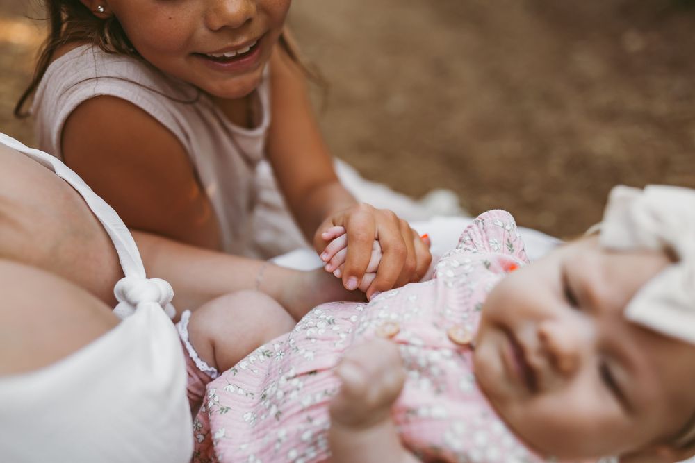 Close up tender moment shared between parent and child relaxing outdoors in natural lighting.