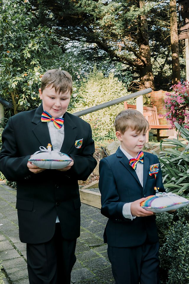 A sequence of candid photos showing children in formal suits enjoying cotton candy outdoors in a garden setting.