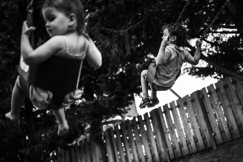 Sequence of children performing flips and tricks on a backyard trampoline at dusk.