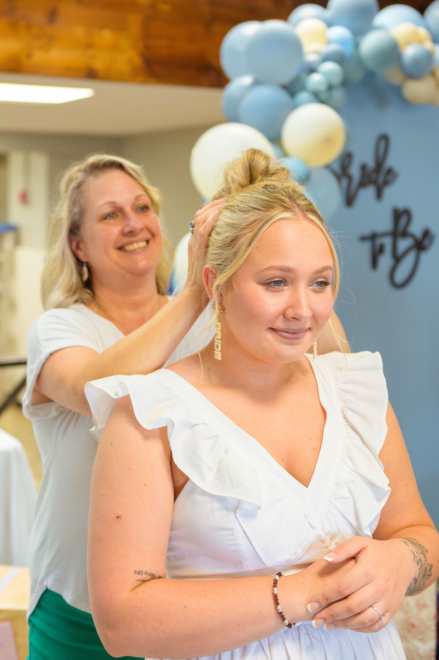 Indoor celebration decorated with blue and white balloons creates a festive atmosphere.