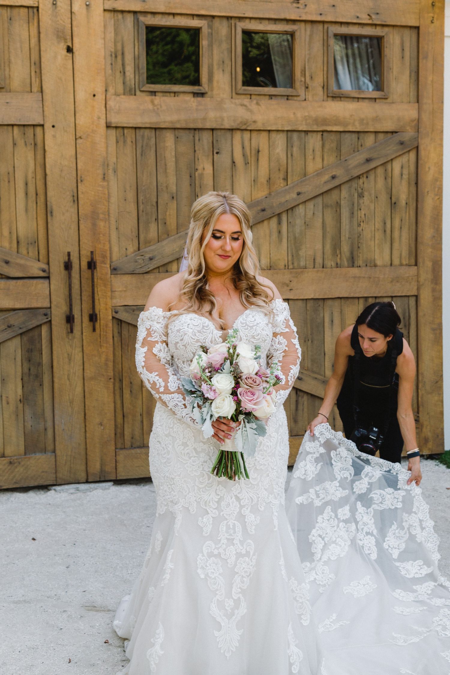 Wedding dress photography session showing flowing white gowns in rustic barn setting.