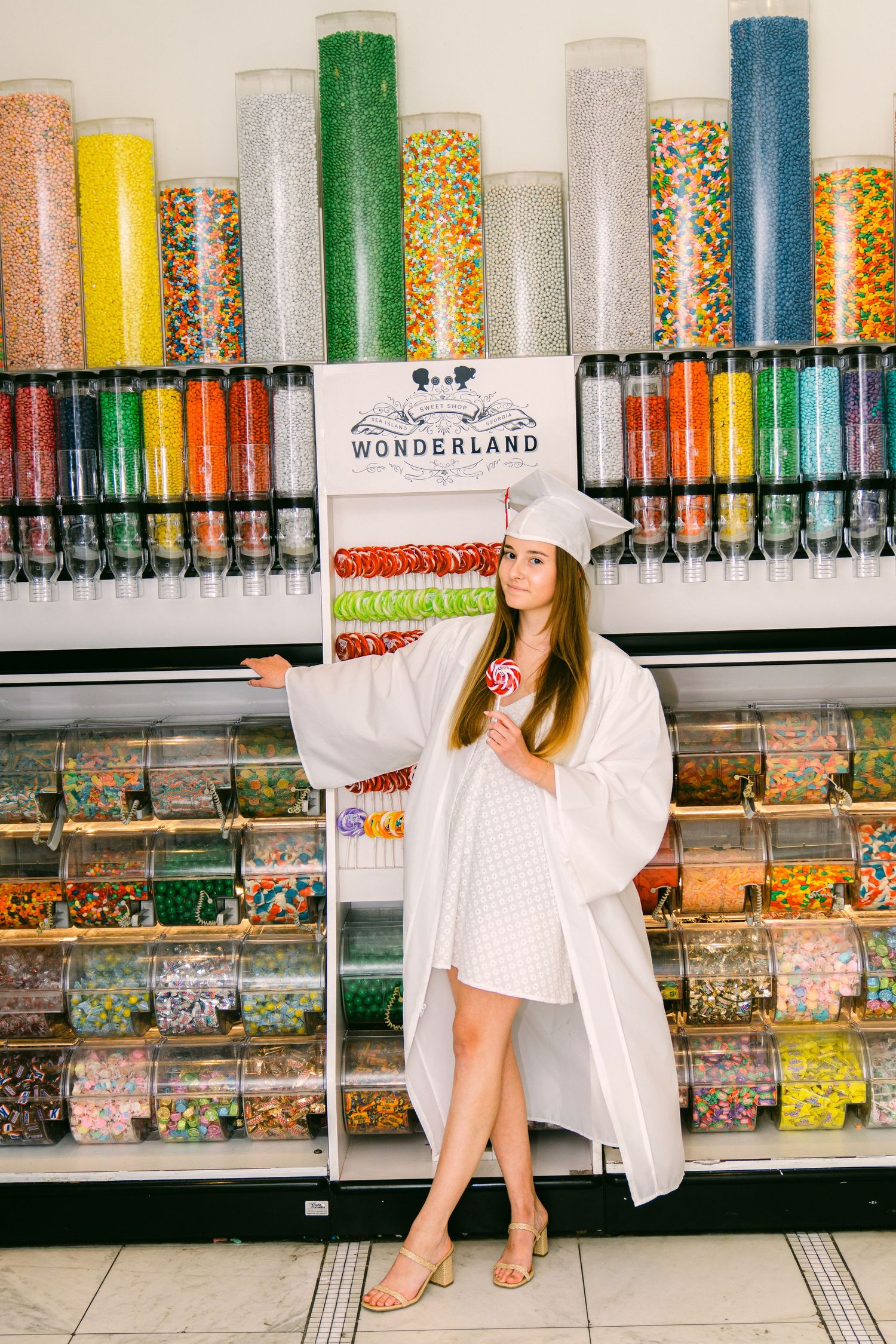 High school senior enjoying a treat at Wonderland at Sea Island Beach Club during a golden hour portrait session