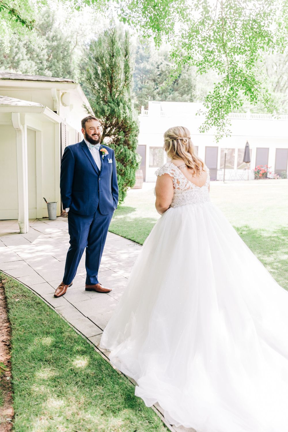A romantic first look sequence showing a couple in wedding attire seeing each other before their ceremony.