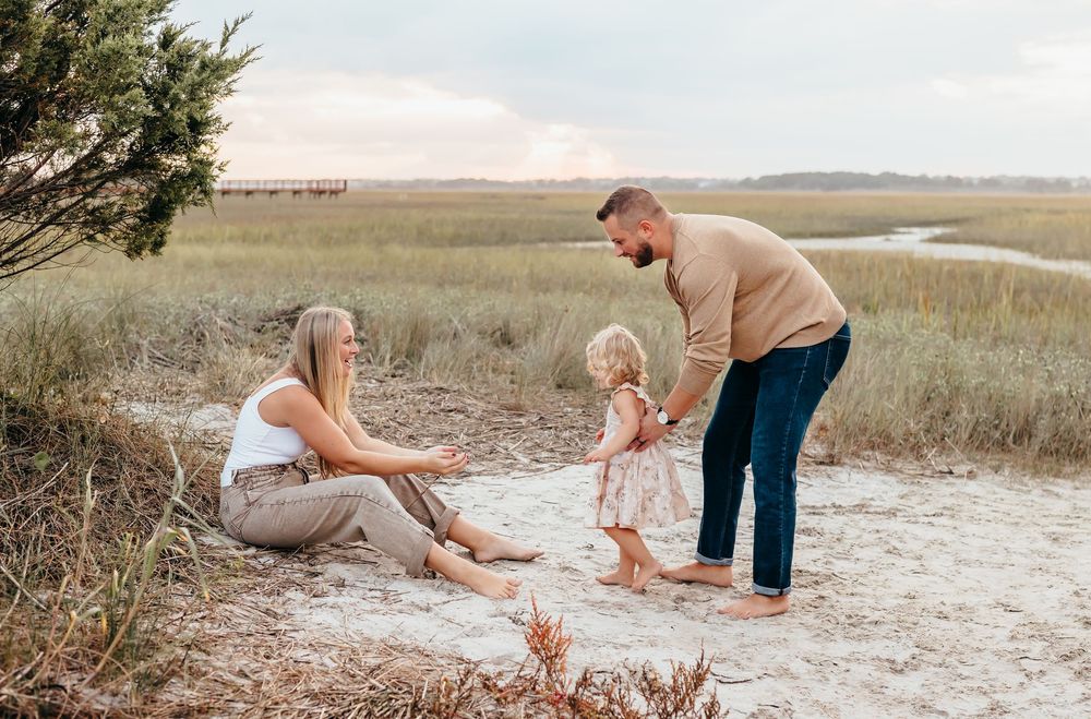 A casual beach photoshoot showing playful moments in a coastal marsh setting. Family photography wilmington north carolina
