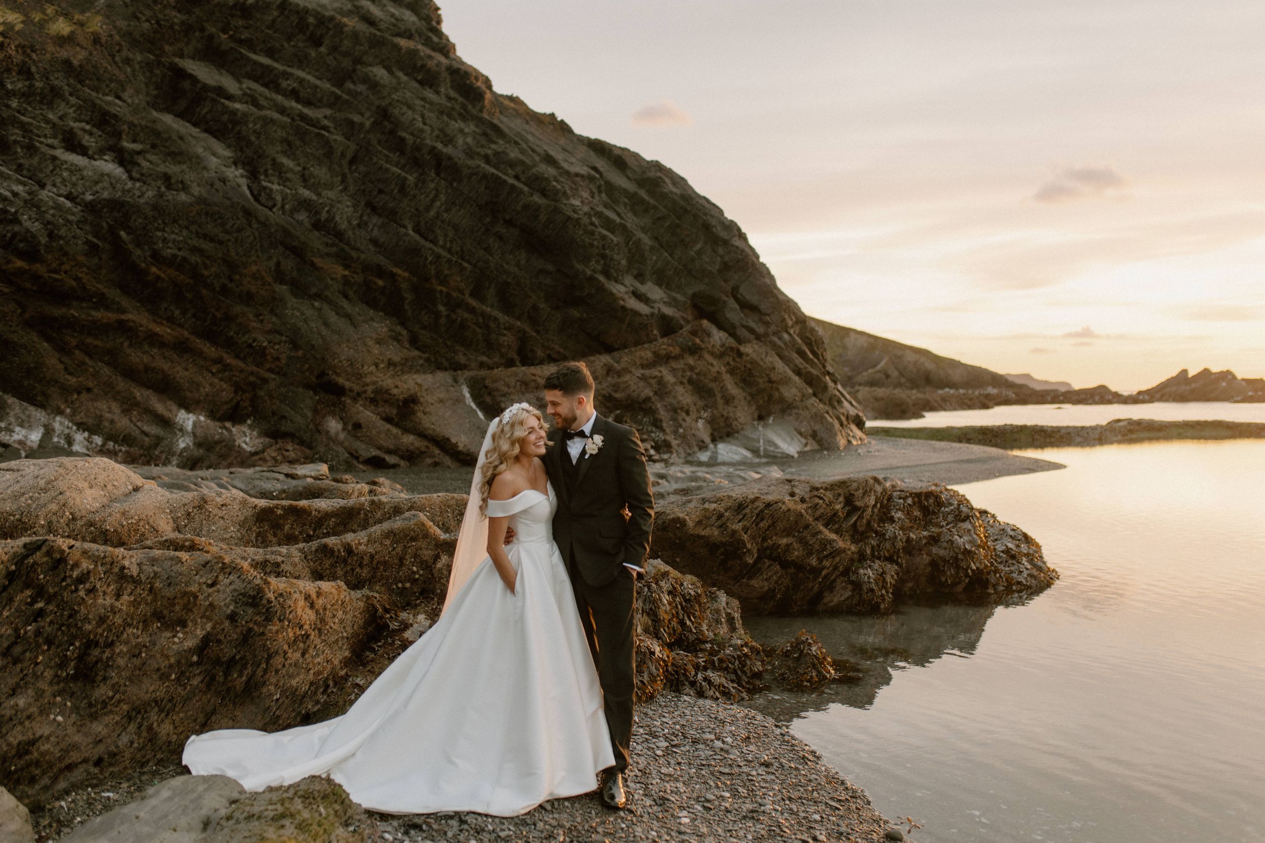 Romantic golden hour wedding portrait at Tunnels Beaches