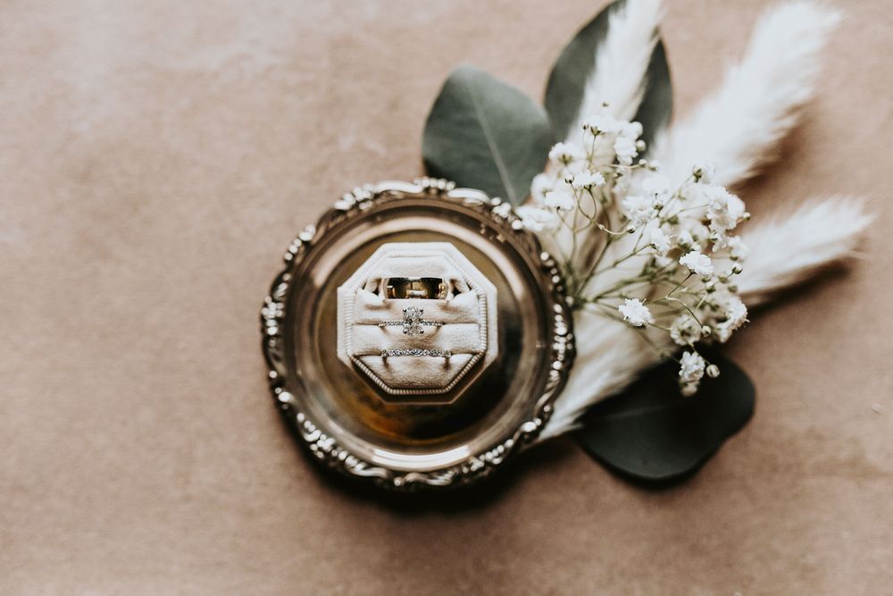 a beautiful boho flat lay photo of the wedding rings