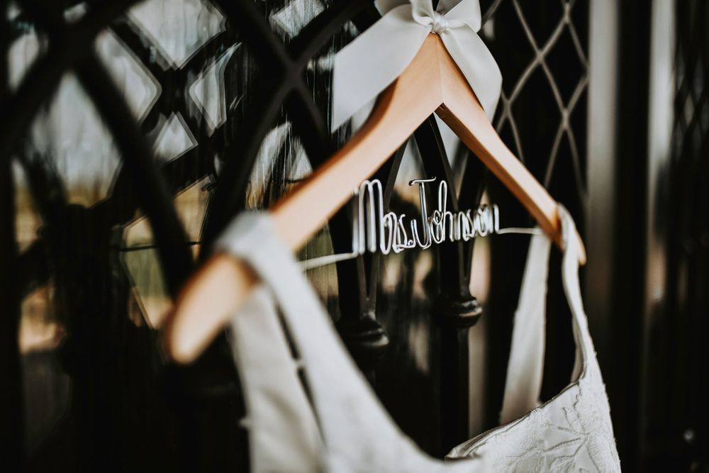 a lovely photo of a personalized wedding gown hanger with the brides new name on it