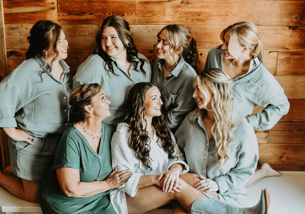 the bridal party cheer in green matching PJS as they get ready for the big day