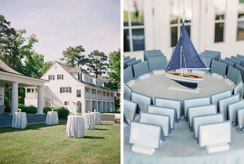 A wedding venue setup with a white colonial house and nautical-themed table decor featuring a model sailboat centerpiece.