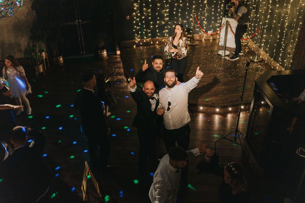 A wedding dance floor glows with blue accent lights and string lights hanging above at Grand Lodge Oaklands - taken by Grimsby photographer.