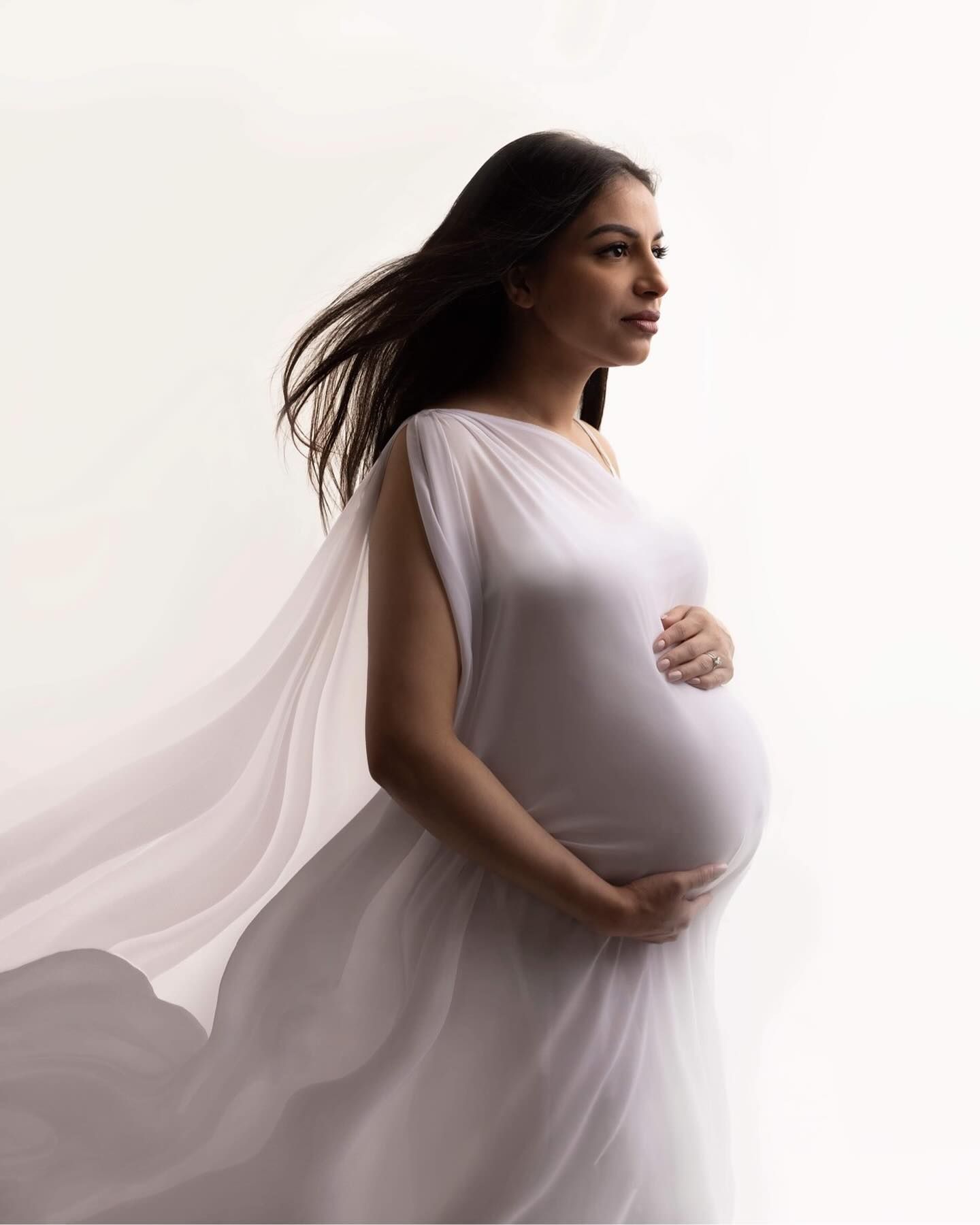 white dress flows in the windMaternity photos Surrey Vancouver Elizabeth Lang Photography