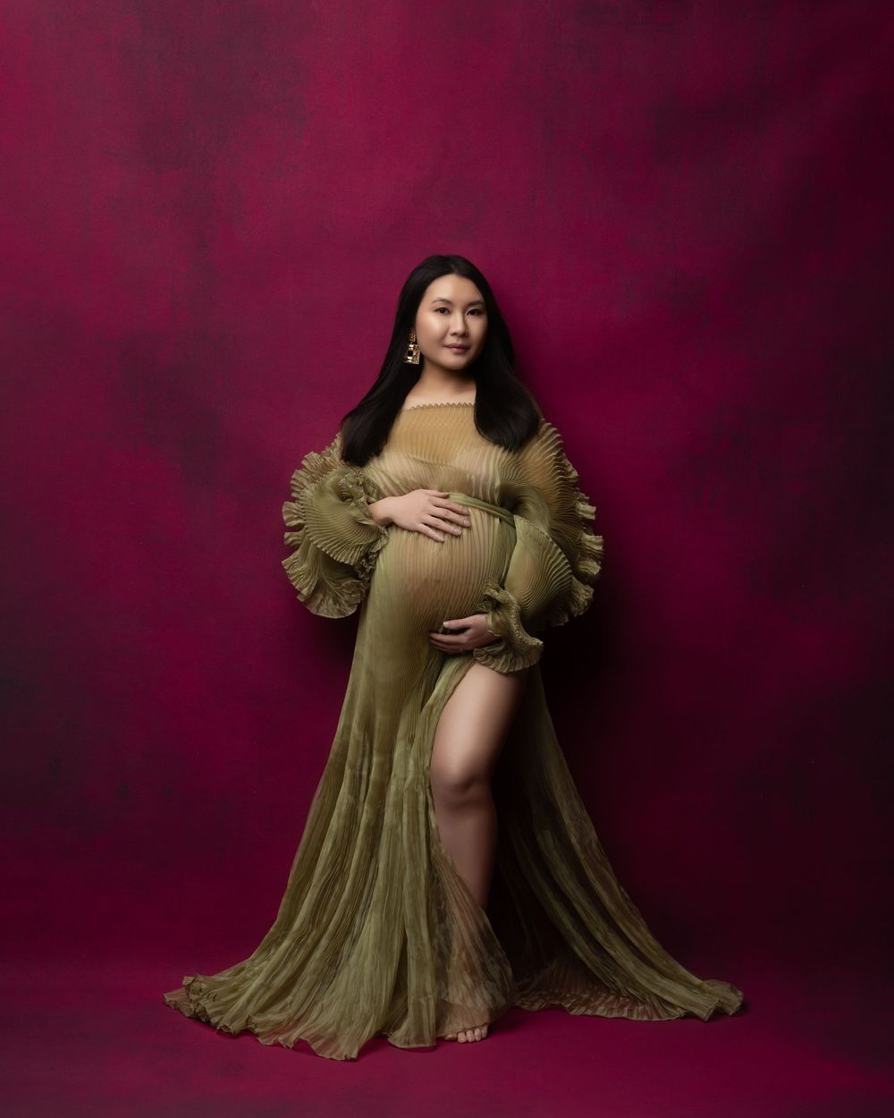 Portrait photos of a figure in olive green pleated dress against dark burgundy background showcasing different poses and angles.