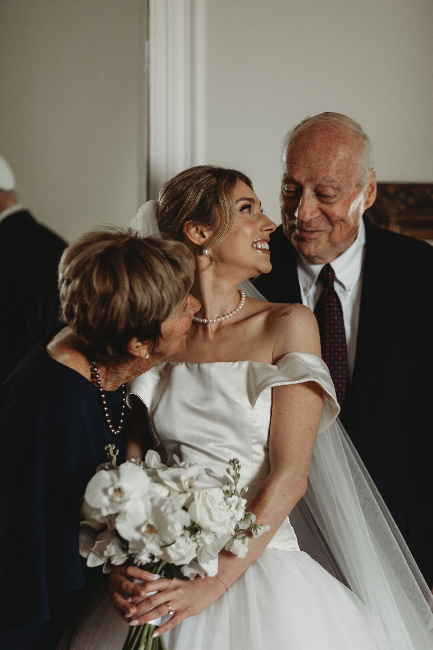 Emotional wedding moment captured in a series of five candid photos showing an embrace between a bride and guest.