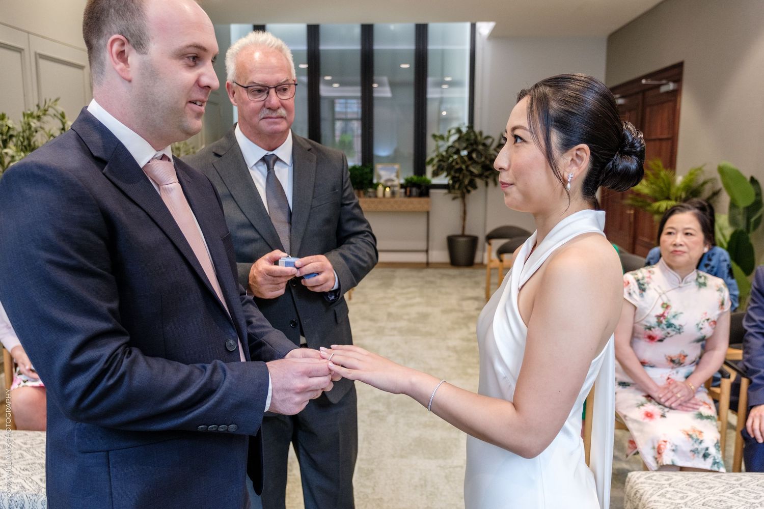 A series of five wedding ceremony photos showing intimate moments between the couple during their special day.